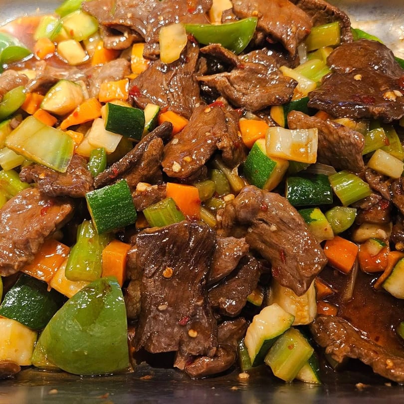 Close-up of Ho Mei Express Chinese Kitchen's beef and mixed vegetables in a savory sauce.