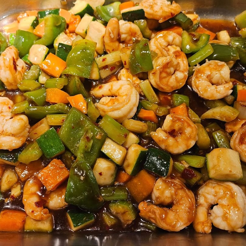 Ho Mei Express Chinese Kitchen's shrimp stir-fry with green peppers, carrots, and zucchini in a rich sauce.